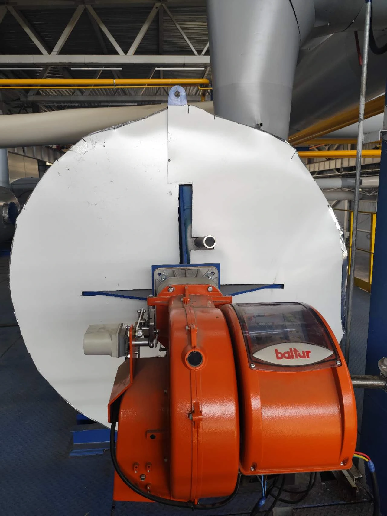 Close view of an orange Baltur burner installed at the Moscow rock wool plant